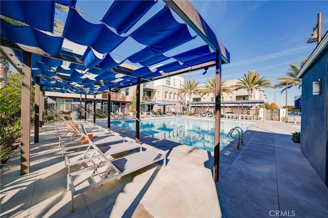 view of pool with a pergola and a patio area