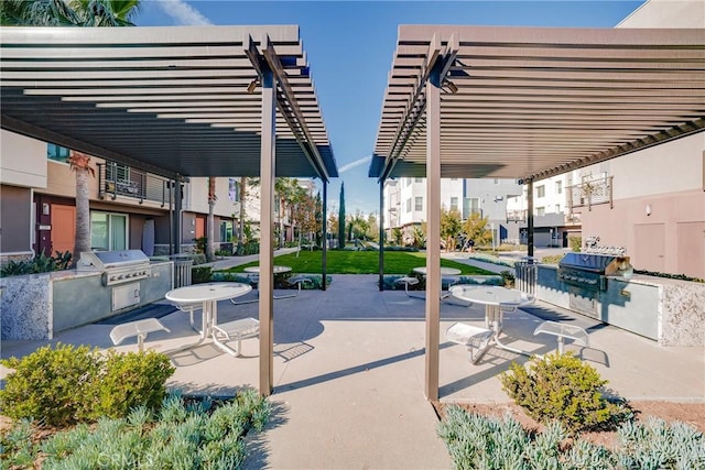 view of patio / terrace featuring a pergola, a grill, and exterior kitchen