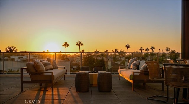 patio terrace at dusk featuring an outdoor hangout area