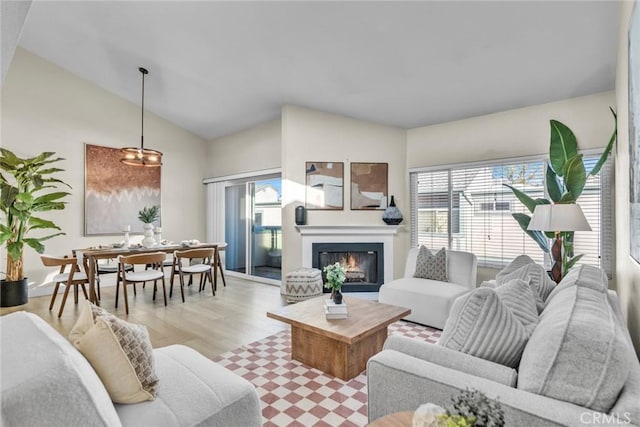 living room featuring light wood-type flooring and vaulted ceiling