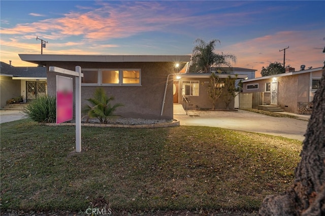 ranch-style house featuring a lawn