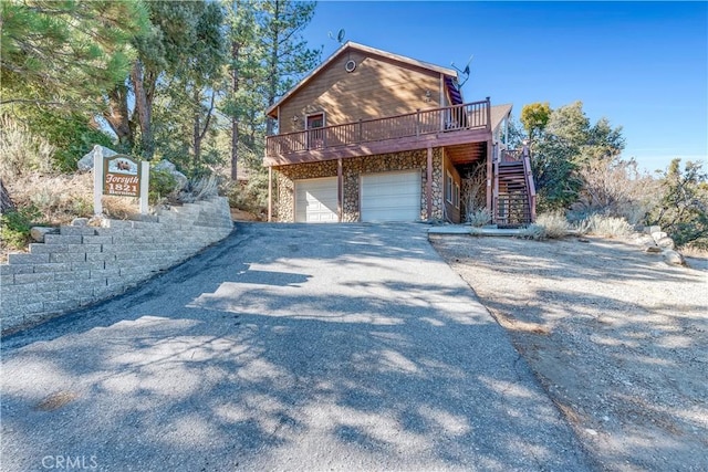 view of front of home featuring a garage and a deck