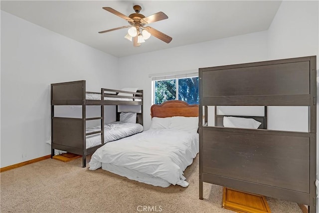 bedroom featuring ceiling fan and light carpet