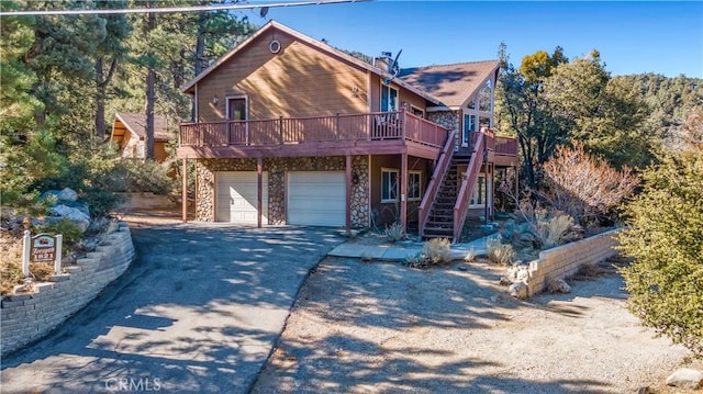 view of front of property with a wooden deck and a garage