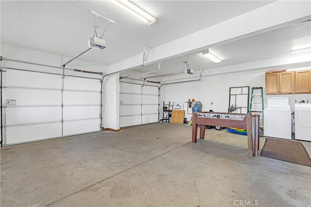 garage featuring a garage door opener and independent washer and dryer