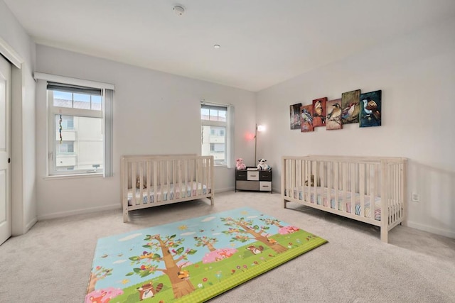 carpeted bedroom with multiple windows