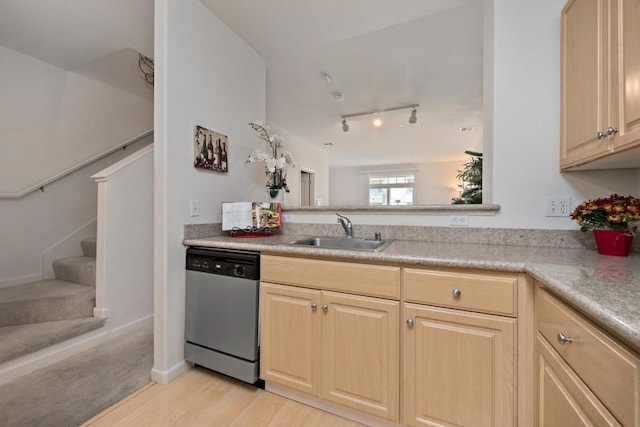 kitchen featuring sink, light hardwood / wood-style flooring, light brown cabinetry, and stainless steel dishwasher