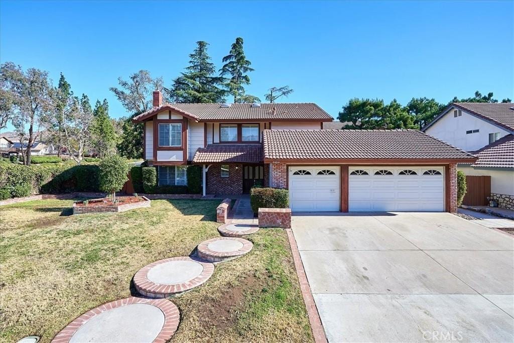 view of front of house with a front lawn and a garage