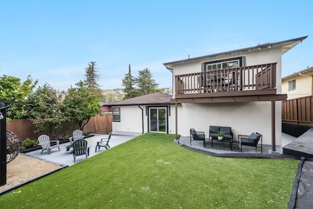 back of house featuring an outdoor living space, a yard, a patio, and a deck