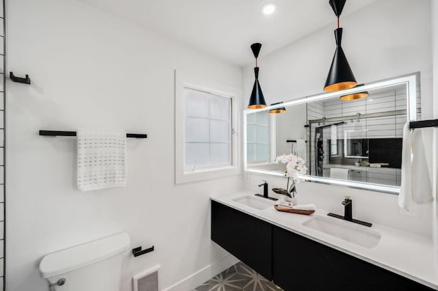 bathroom with tile patterned floors, vanity, and toilet