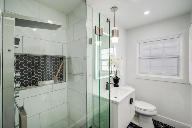 bathroom with vanity, toilet, and walk in shower