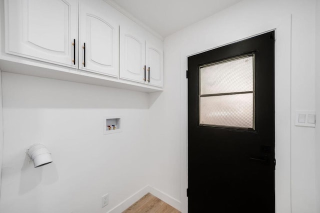 laundry area with cabinets, hookup for a washing machine, and light wood-type flooring