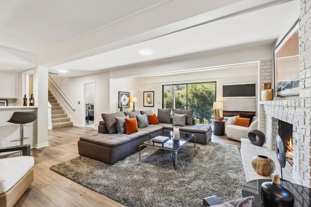 living room with a fireplace and light hardwood / wood-style floors