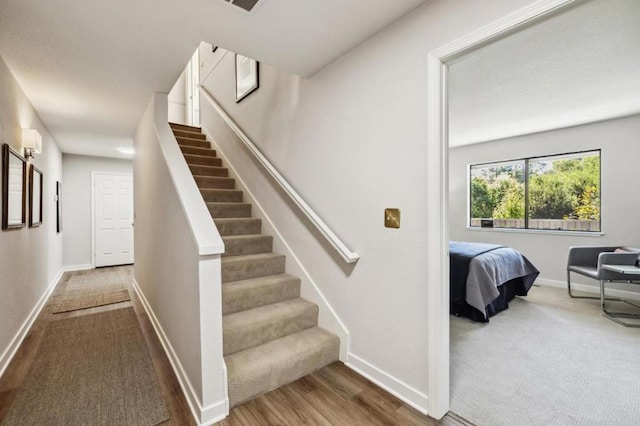 stairs with wood-type flooring