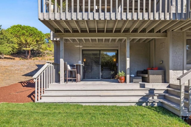 property entrance with a balcony and outdoor lounge area