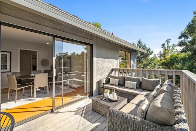 wooden terrace with an outdoor living space