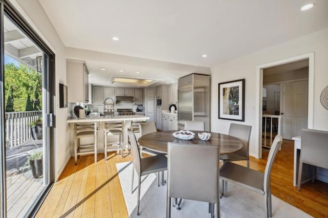 dining room featuring light hardwood / wood-style flooring and plenty of natural light