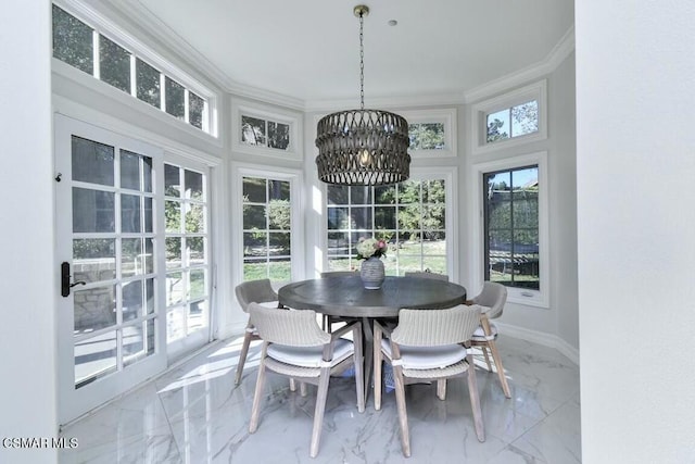 sunroom / solarium featuring a chandelier