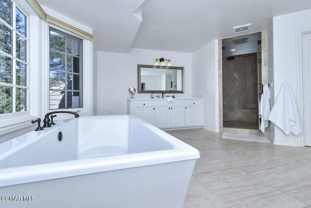 bathroom with vanity and independent shower and bath