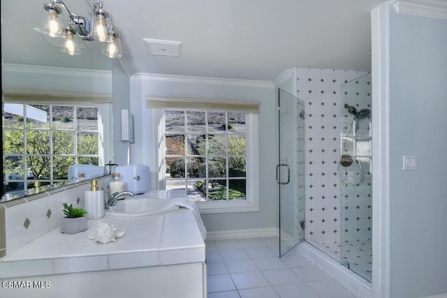 bathroom featuring sink, walk in shower, tile patterned flooring, and ornamental molding