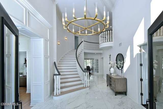 entrance foyer featuring a notable chandelier, french doors, and a high ceiling