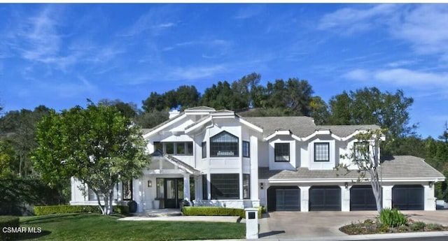 view of front of home featuring a garage and a front lawn