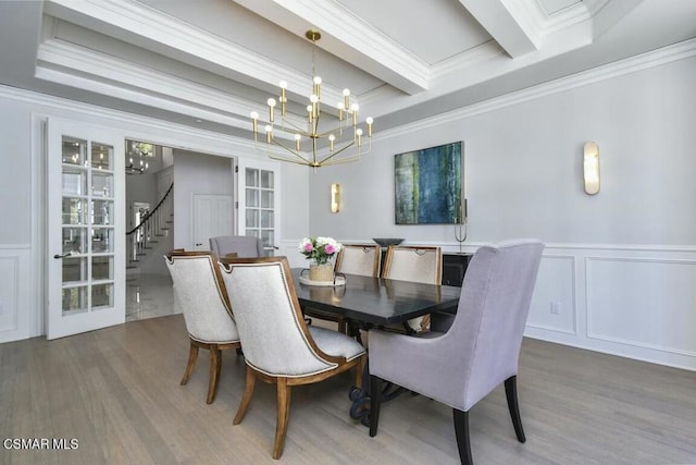 dining room featuring an inviting chandelier, ornamental molding, beamed ceiling, and hardwood / wood-style floors