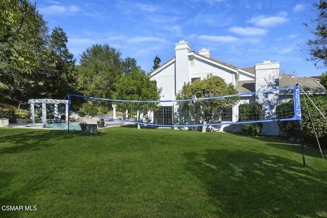 view of community featuring a lawn and a pergola