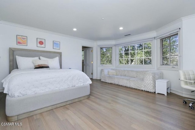 bedroom featuring hardwood / wood-style flooring and ornamental molding