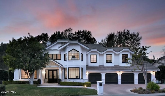 view of front of home featuring a garage and a lawn