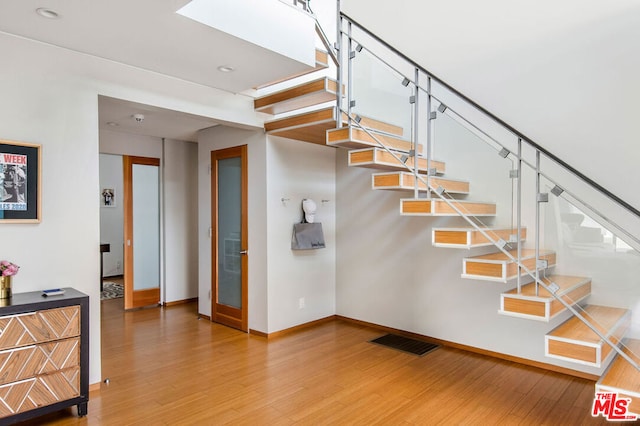 staircase featuring hardwood / wood-style floors