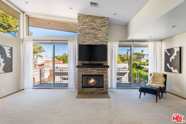 living room with light colored carpet and a fireplace