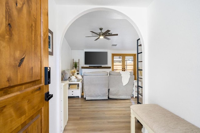 living room with ceiling fan, french doors, and light hardwood / wood-style floors