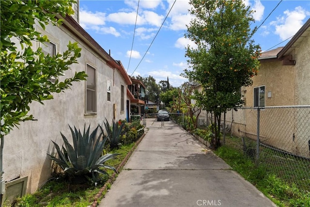 exterior space with concrete driveway, a gated entry, and a gate