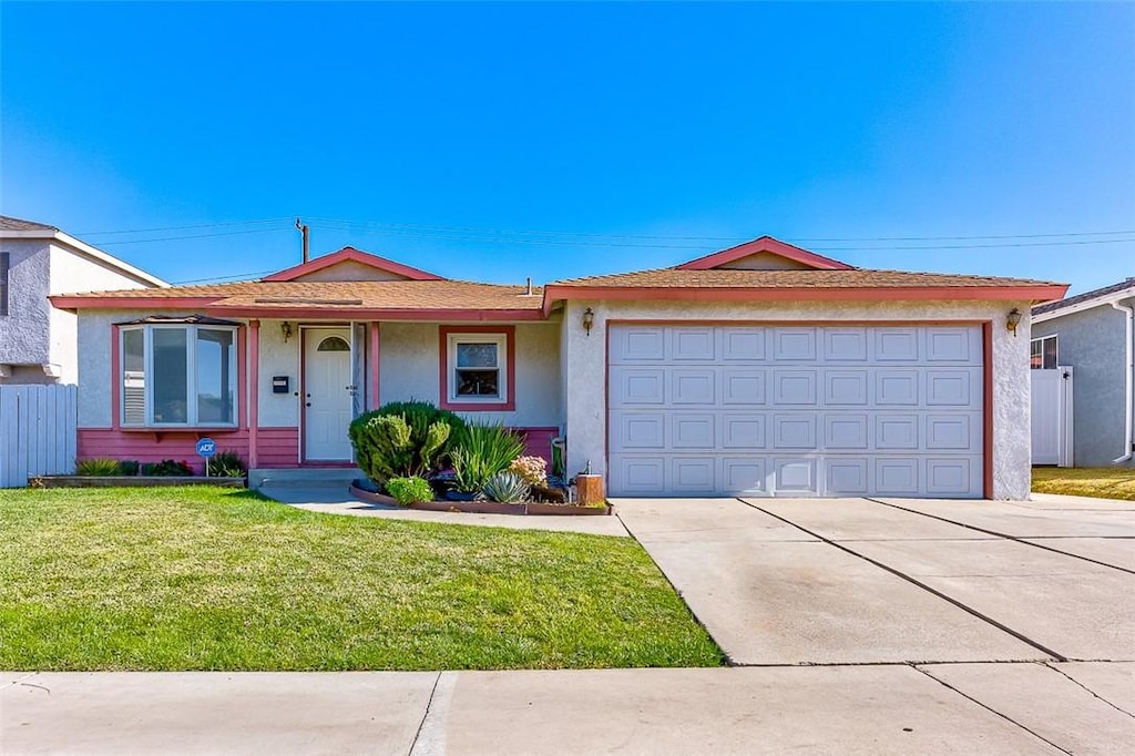 single story home featuring a front lawn and a garage