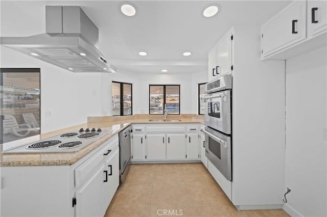 kitchen featuring white cabinets, island range hood, stainless steel appliances, and sink