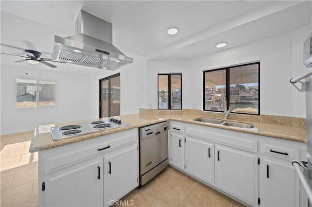 kitchen featuring kitchen peninsula, stainless steel dishwasher, sink, exhaust hood, and white cabinets