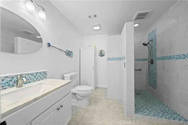 bathroom featuring decorative backsplash, toilet, a tile shower, and vanity