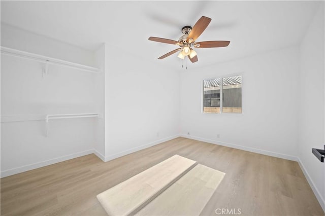 unfurnished room featuring light wood-type flooring and ceiling fan