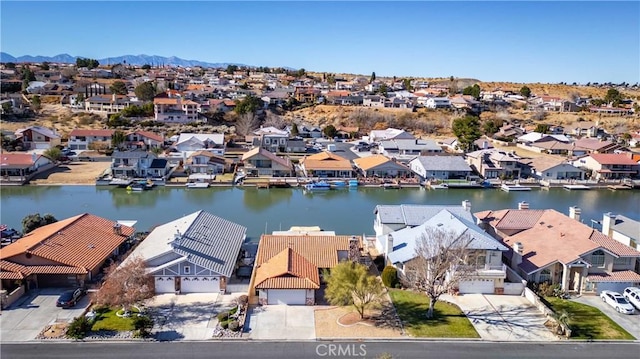 birds eye view of property featuring a water and mountain view