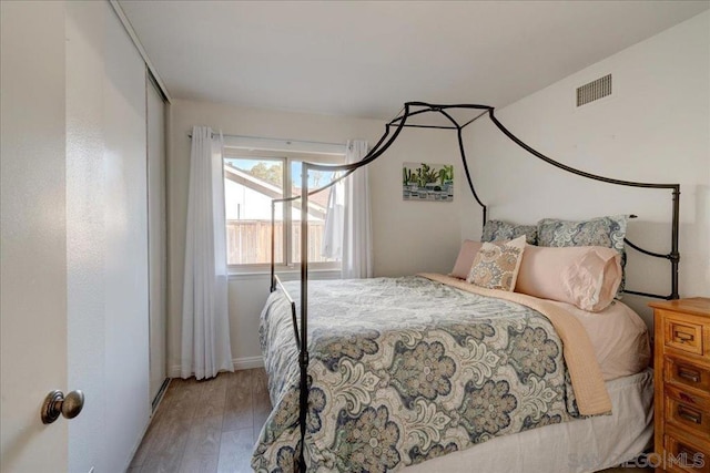 bedroom with hardwood / wood-style flooring