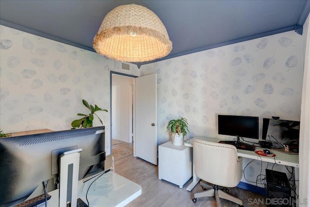 office space featuring ornamental molding and wood-type flooring