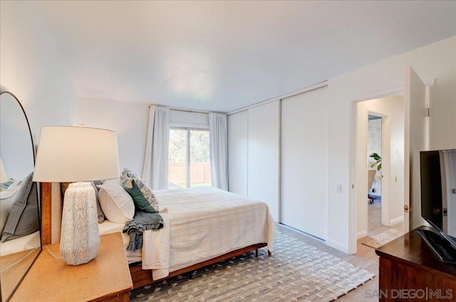 bedroom with a closet and hardwood / wood-style flooring