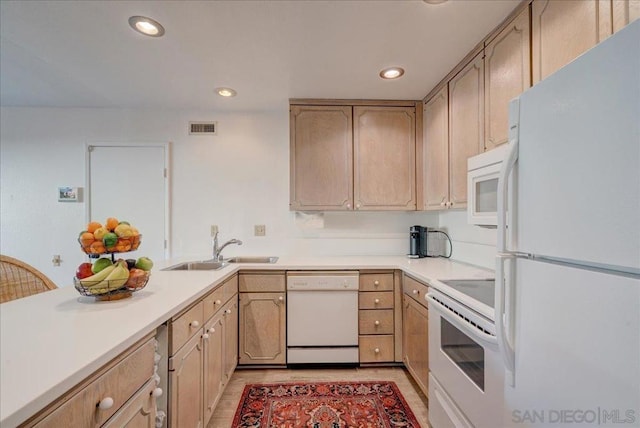 kitchen with sink, light brown cabinets, white appliances, and light hardwood / wood-style flooring