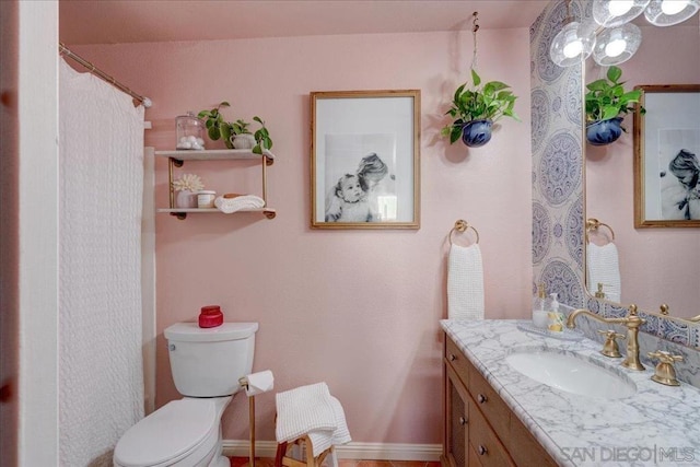 bathroom featuring toilet and vanity