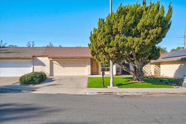 view of front facade with a front yard and a garage