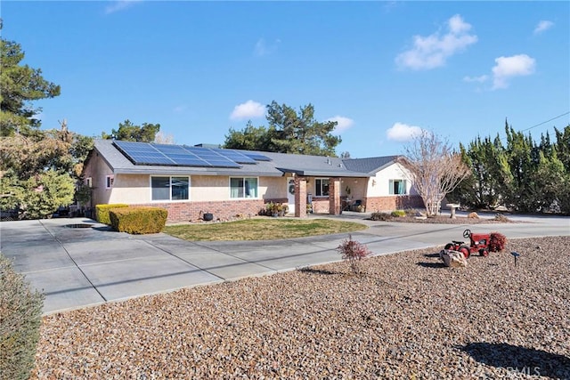 ranch-style home with solar panels