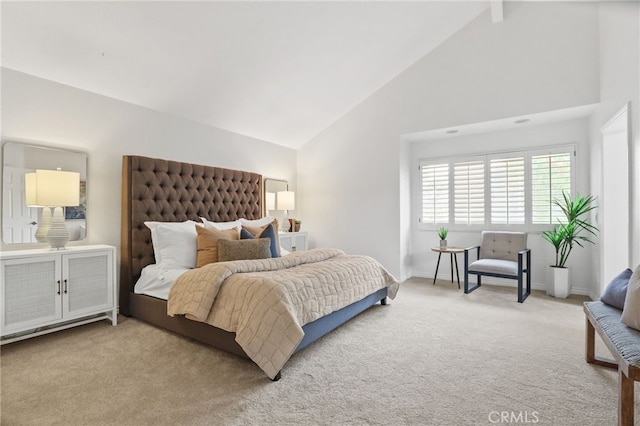 carpeted bedroom featuring high vaulted ceiling