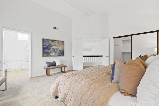 bedroom with high vaulted ceiling, visible vents, baseboards, beamed ceiling, and carpet