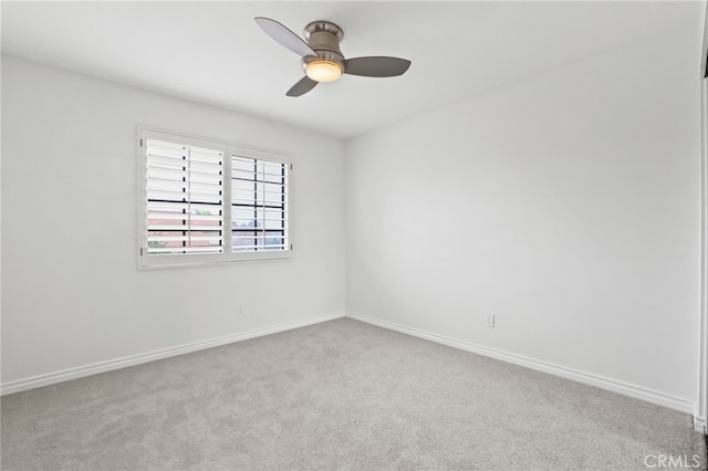 spare room featuring carpet floors, ceiling fan, and baseboards